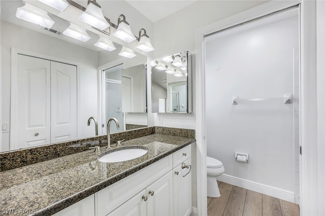 bathroom featuring toilet and vanity