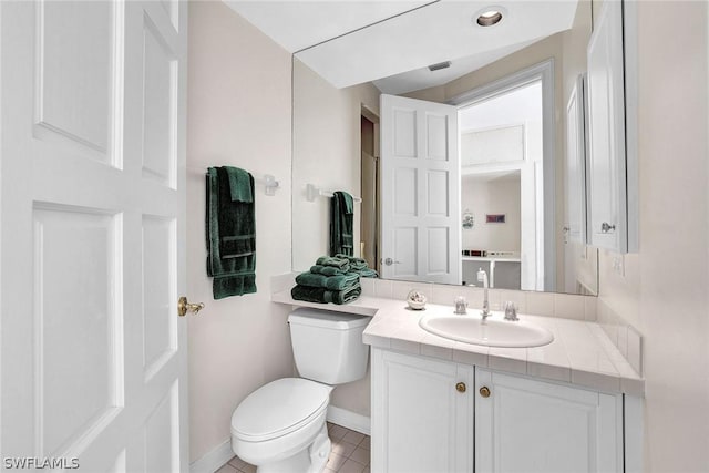 bathroom with tile patterned floors, vanity, and toilet