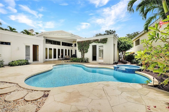 view of swimming pool featuring a patio area and an in ground hot tub