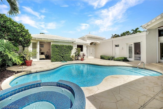 view of pool featuring a patio area and an in ground hot tub