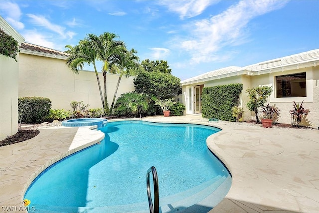 view of pool featuring an in ground hot tub and a patio