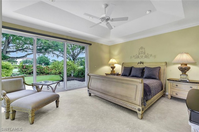 carpeted bedroom with a tray ceiling, ceiling fan, crown molding, and access to outside