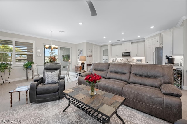 living room featuring a chandelier and crown molding