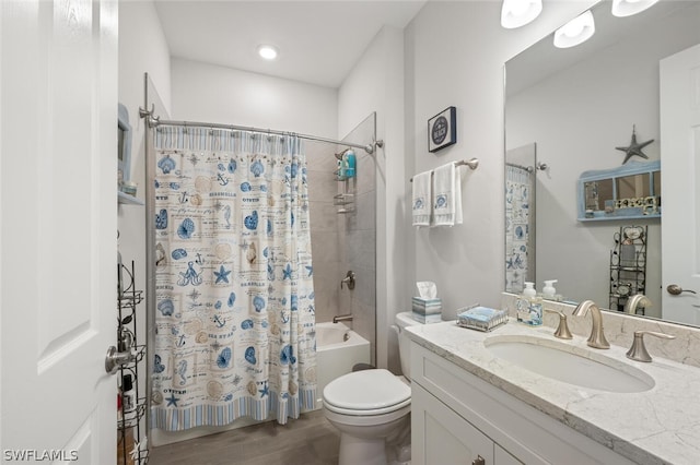 full bathroom with toilet, hardwood / wood-style flooring, vanity, and shower / tub combo with curtain