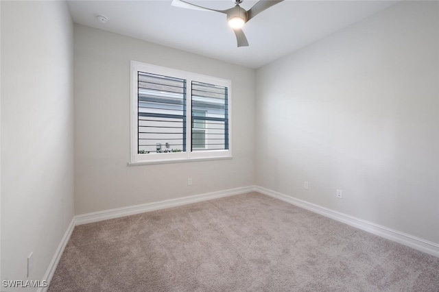 carpeted empty room featuring ceiling fan