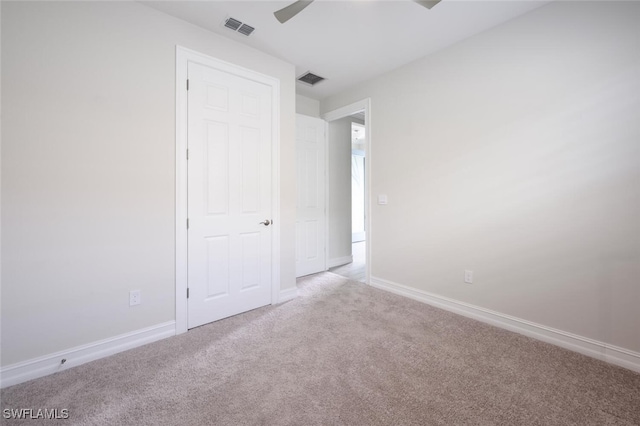 unfurnished bedroom featuring ceiling fan and light colored carpet