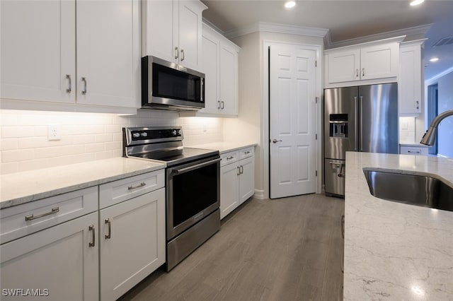 kitchen featuring stainless steel appliances, sink, and white cabinets