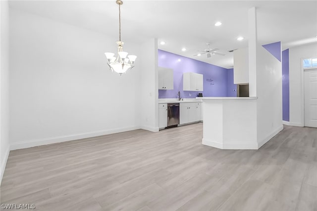 kitchen featuring stainless steel dishwasher, pendant lighting, light hardwood / wood-style floors, white cabinets, and ceiling fan with notable chandelier