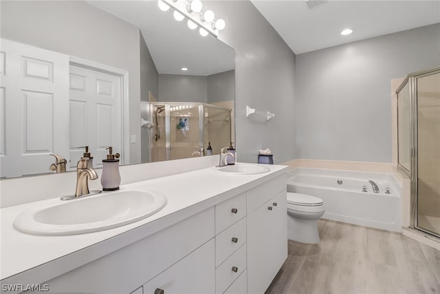 full bathroom featuring vanity, hardwood / wood-style flooring, plus walk in shower, and toilet