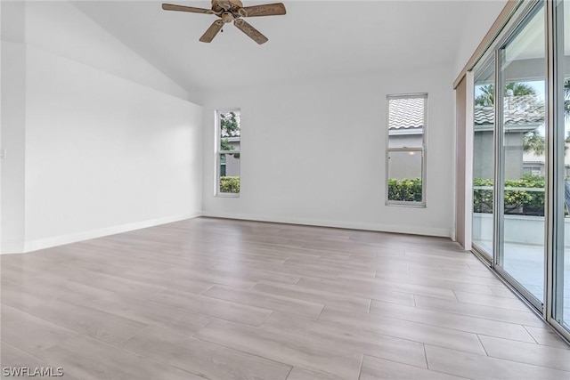 empty room featuring ceiling fan and lofted ceiling