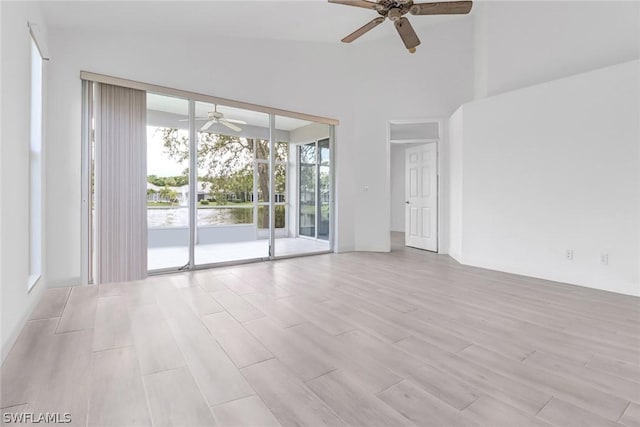 empty room featuring ceiling fan and vaulted ceiling