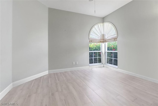 3357 Wildwood Lake Cir, Bonita Springs, FL 34134 - empty room with light wood-style flooring, a ceiling fan, and baseboards