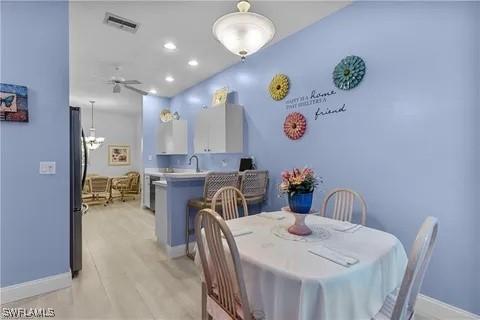 dining area featuring ceiling fan and sink