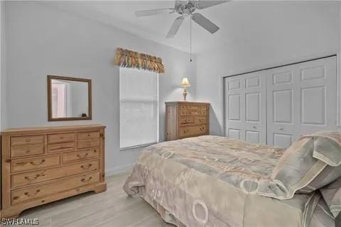 bedroom featuring ceiling fan, light wood-type flooring, and a closet