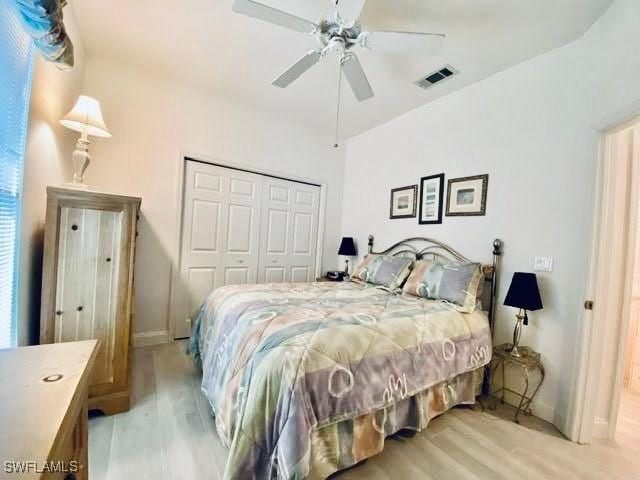 bedroom with ceiling fan, a closet, and light wood-type flooring