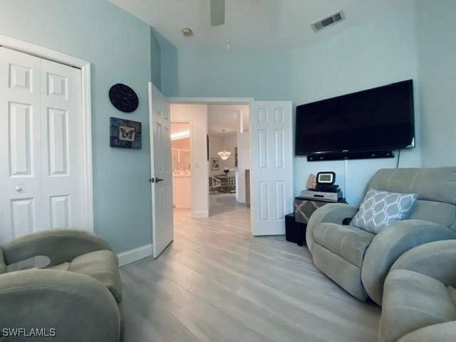 living room with ceiling fan and light hardwood / wood-style floors