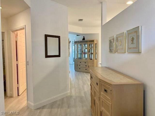 3357 Wildwood Lake Cir, Bonita Springs, FL 34134 - hall with light wood-style floors, baseboards, and visible vents