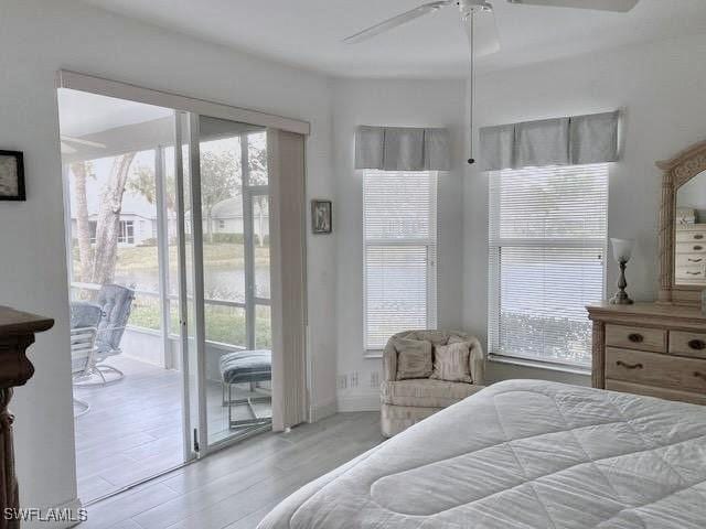 bedroom featuring access to outside, light hardwood / wood-style flooring, and ceiling fan