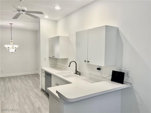 3357 Wildwood Lake Cir, Bonita Springs, FL 34134 - kitchen with baseboards, light wood-style flooring, light countertops, dishwasher, and a sink