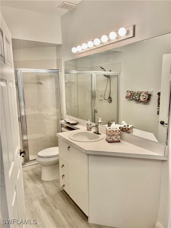 3357 Wildwood Lake Cir, Bonita Springs, FL 34134 - full bath featuring toilet, vanity, visible vents, and a stall shower