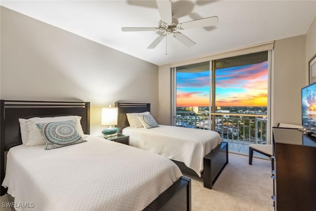 bedroom with ceiling fan, access to exterior, light colored carpet, and floor to ceiling windows