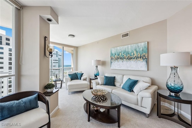 living room featuring light colored carpet and expansive windows