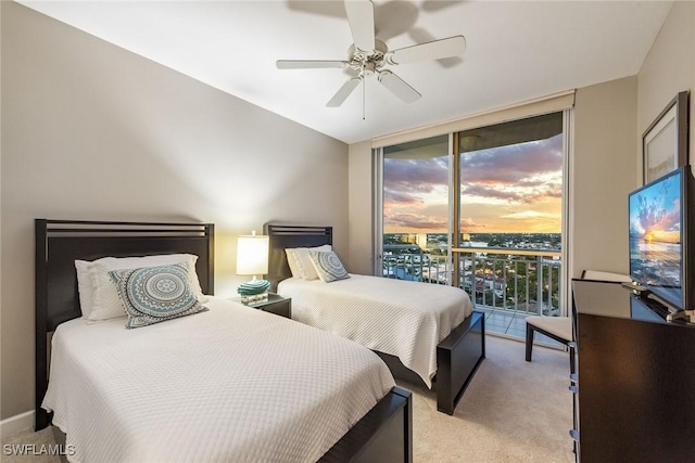 carpeted bedroom with ceiling fan, multiple windows, access to outside, and floor to ceiling windows