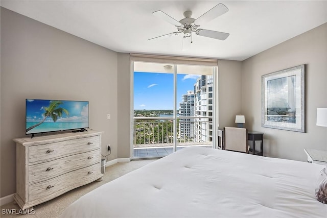 carpeted bedroom featuring access to outside, ceiling fan, and multiple windows