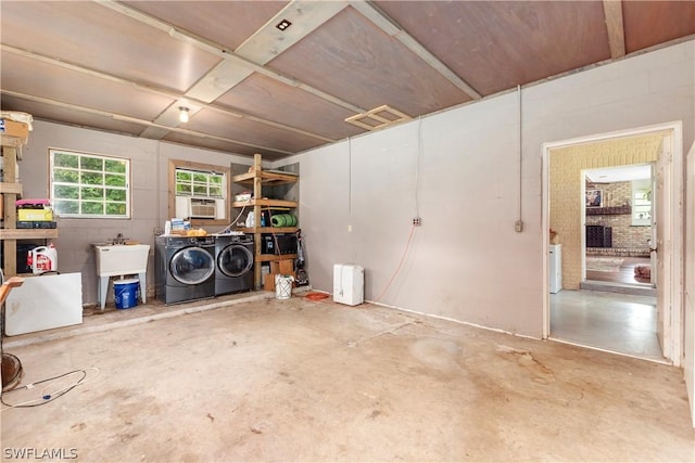 basement with sink and washer and dryer