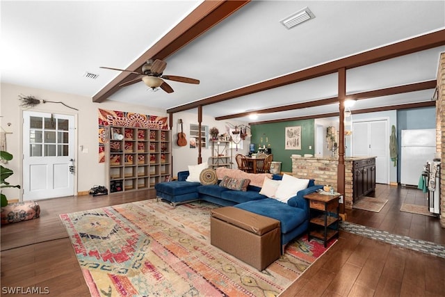 living room featuring beamed ceiling, dark wood-type flooring, and ceiling fan