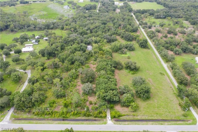 birds eye view of property with a rural view