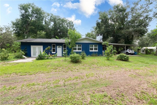 single story home featuring a carport, a front yard, and french doors