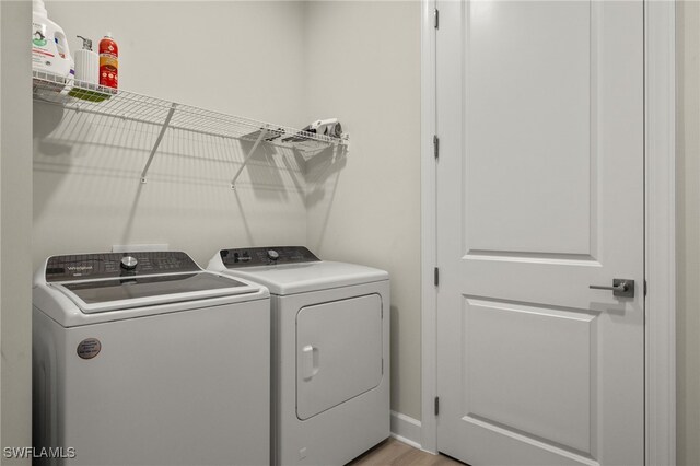 clothes washing area featuring laundry area and separate washer and dryer