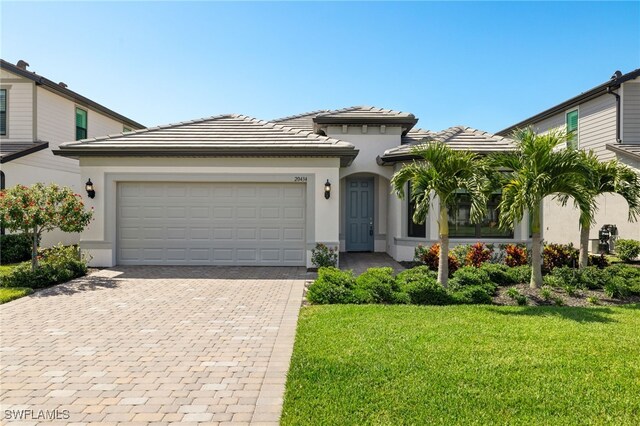 view of front of house with a garage and a front yard