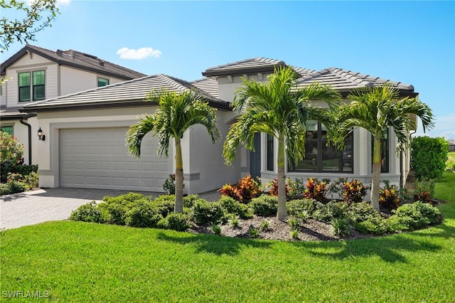 view of front of property with a front yard, decorative driveway, and stucco siding