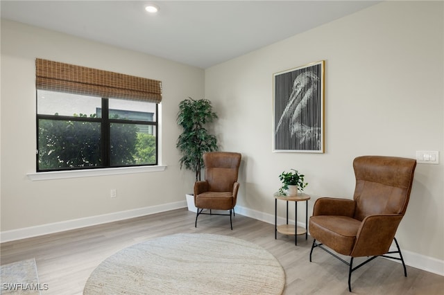 sitting room featuring baseboards, wood finished floors, and recessed lighting