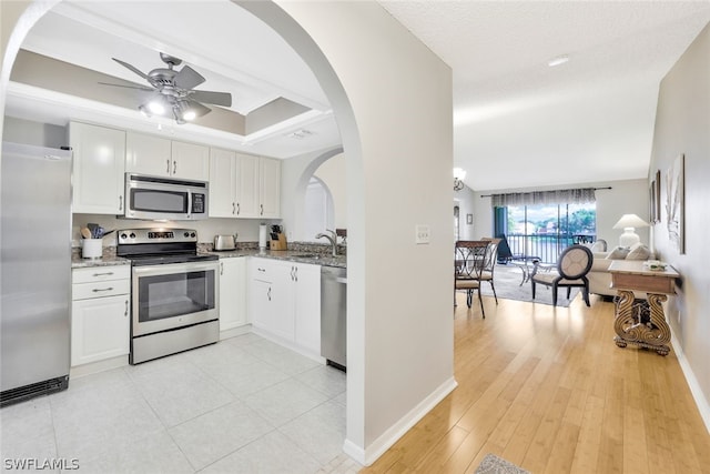 kitchen with ceiling fan, sink, white cabinets, and appliances with stainless steel finishes