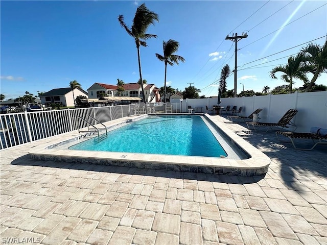 4563 SE 5th Pl Unit 205, Cape Coral, FL 33904 - community pool with a fenced backyard and a patio area