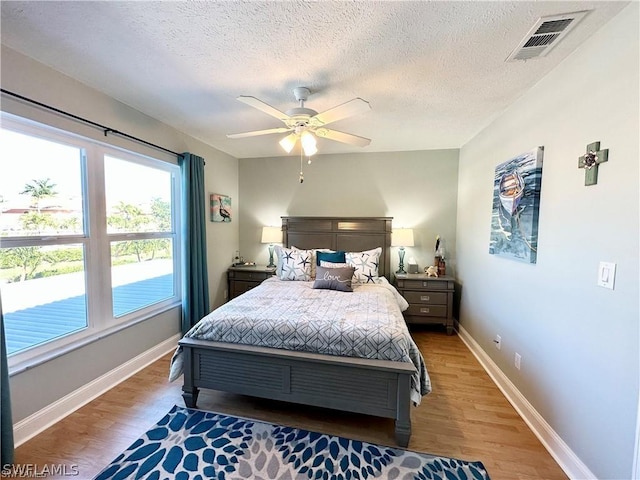 4563 SE 5th Pl Unit 205, Cape Coral, FL 33904 - bedroom with baseboards, visible vents, light wood-style floors, and a ceiling fan
