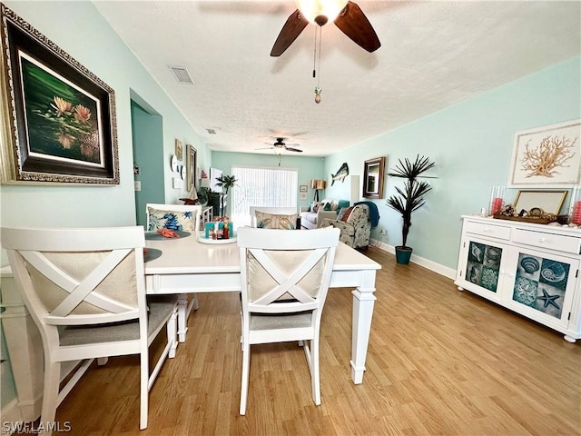 interior space featuring light wood-type flooring, ceiling fan, and a textured ceiling