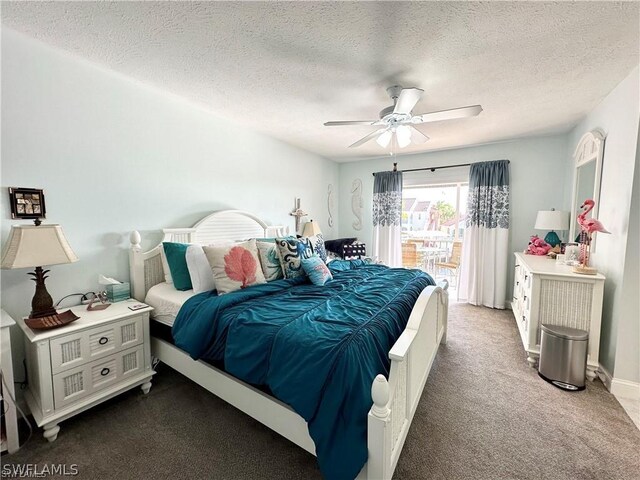 carpeted bedroom featuring a textured ceiling and ceiling fan