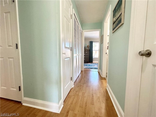 hallway with light hardwood / wood-style flooring