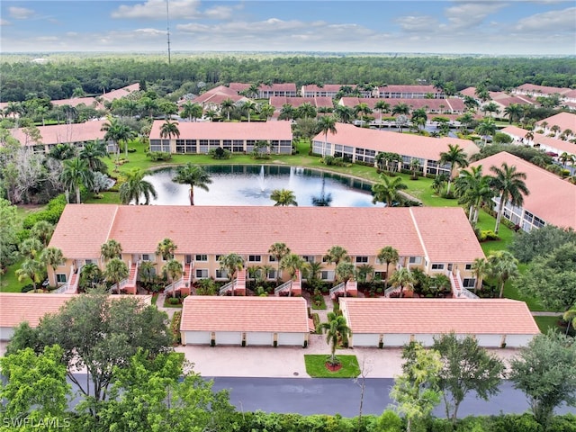 drone / aerial view with a water view and a residential view