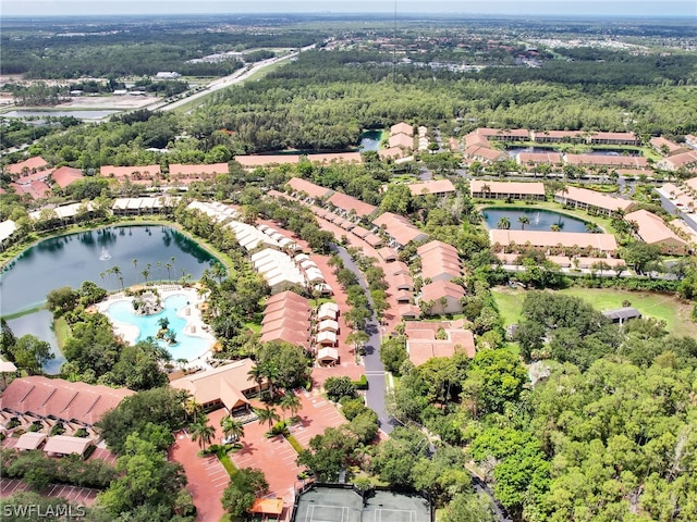 aerial view featuring a water view and a view of trees