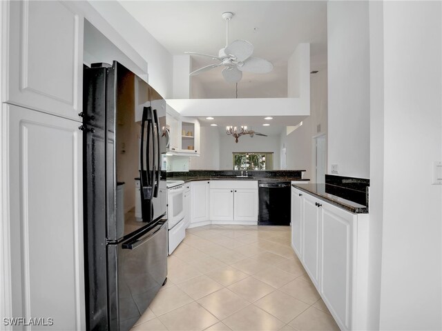 kitchen with kitchen peninsula, ceiling fan with notable chandelier, black appliances, light tile patterned floors, and white cabinets