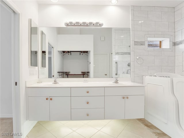 bathroom featuring tile patterned flooring and vanity