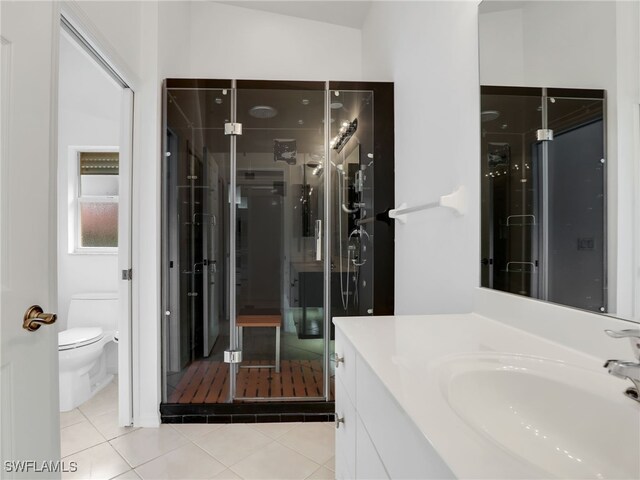 bathroom with vanity, lofted ceiling, tile patterned floors, toilet, and walk in shower