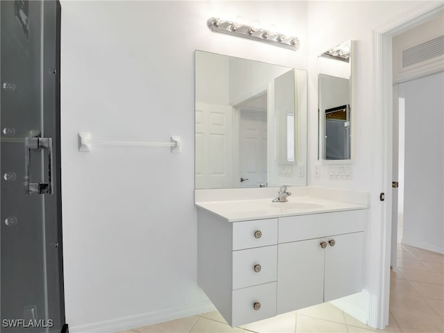 bathroom with tile patterned flooring and vanity