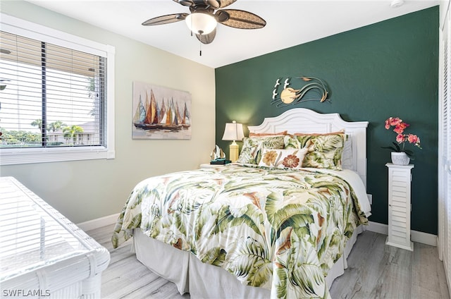 bedroom featuring light hardwood / wood-style floors and ceiling fan