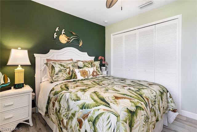 bedroom with ceiling fan, a closet, and light wood-type flooring